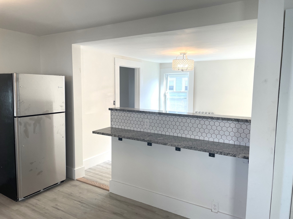 23 Foster Street Springfield, MA 01105 - Photo 5 of 15 a kitchen with a refrigerator and a sink