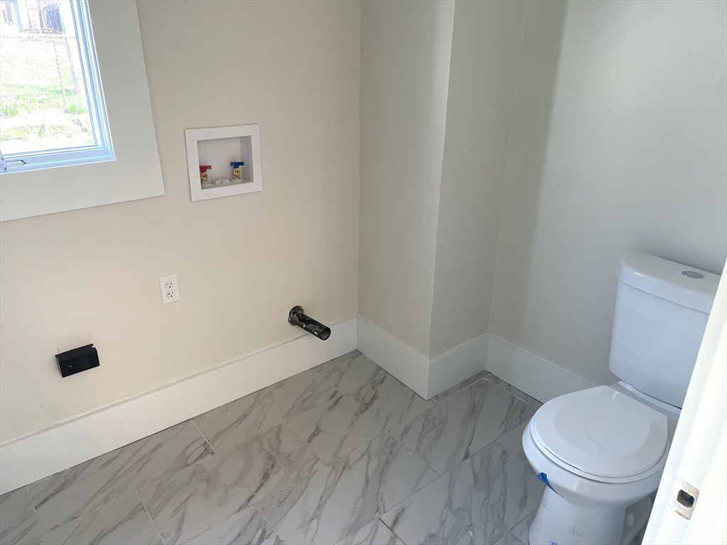 23 Foster Street Springfield, MA 01105 - Photo 6 of 15 a white toilet sitting next to a window