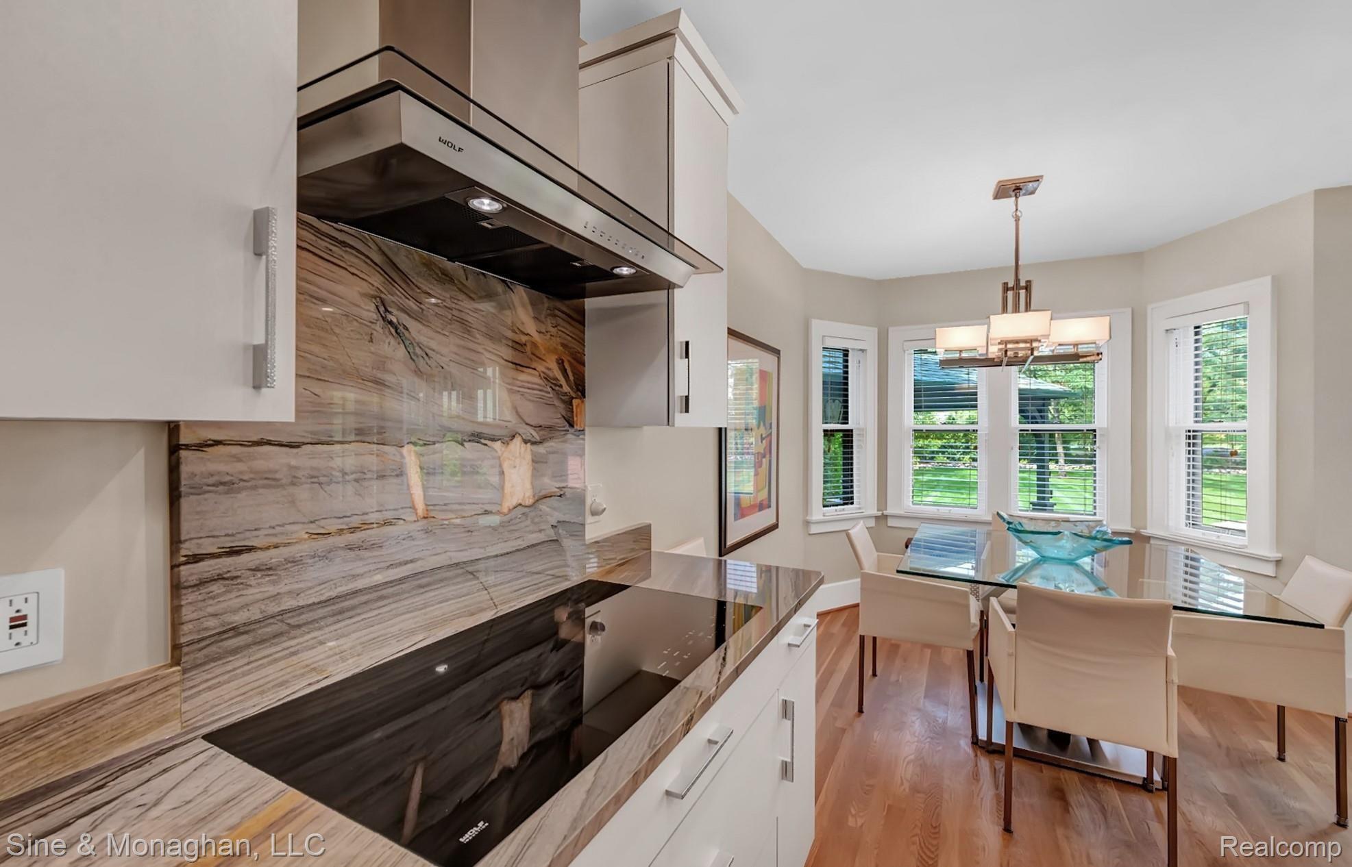 1158 West Maple Road Birmingham, MI 48009 - Photo 25 of 77 Cooktop with granite backsplash, Wolf vent hood