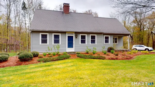 a front view of a house with swimming pool and patio