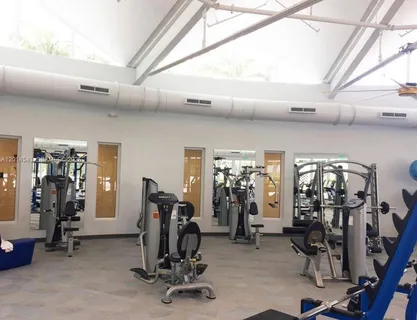 a room with gym equipment and floor to ceiling window