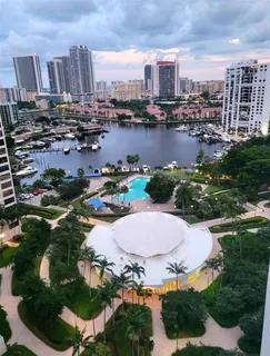 an aerial view of residential houses with outdoor space and lake view