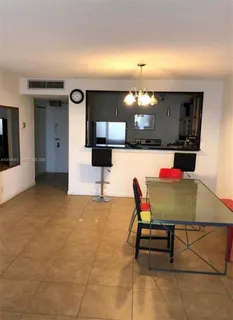 a living room with furniture a chandelier and a flat screen tv