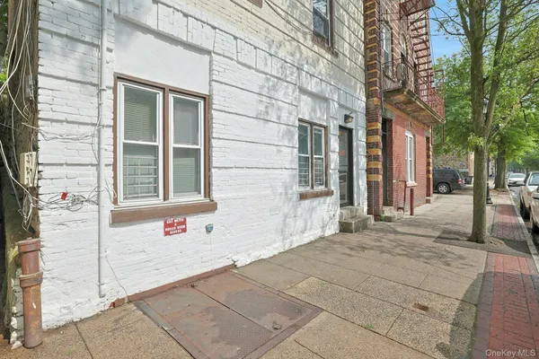 a front view of a building with a yard