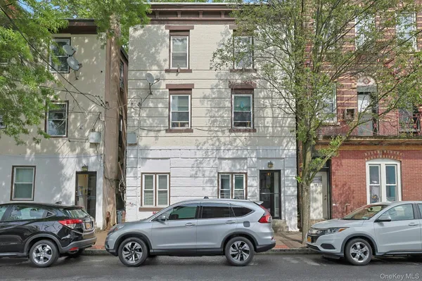 a car parked in front of a brick house