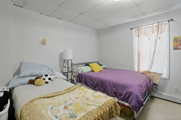 a bedroom with two bed and a window