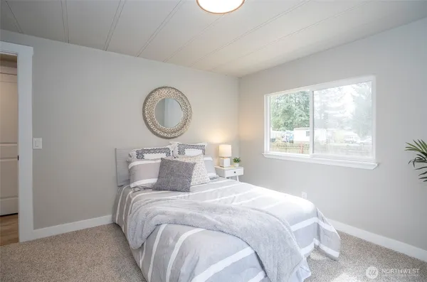 a bedroom with bed and a window