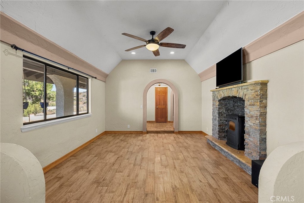 902 Searchlight Ranch Road Acton, CA 93510 - Photo 16 of 52 a view of an empty room with a fireplace and a window