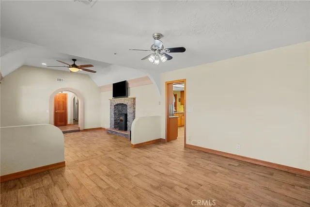 a view of a livingroom with a fireplace and a chandelier