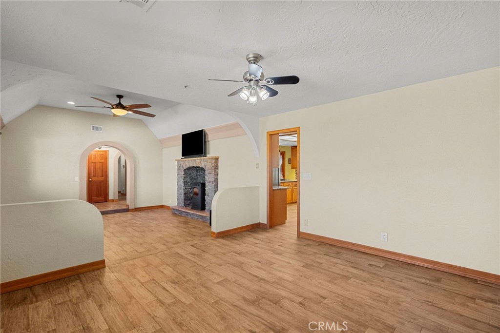 902 Searchlight Ranch Road Acton, CA 93510 - Photo 18 of 52 a view of a livingroom with a fireplace and a chandelier