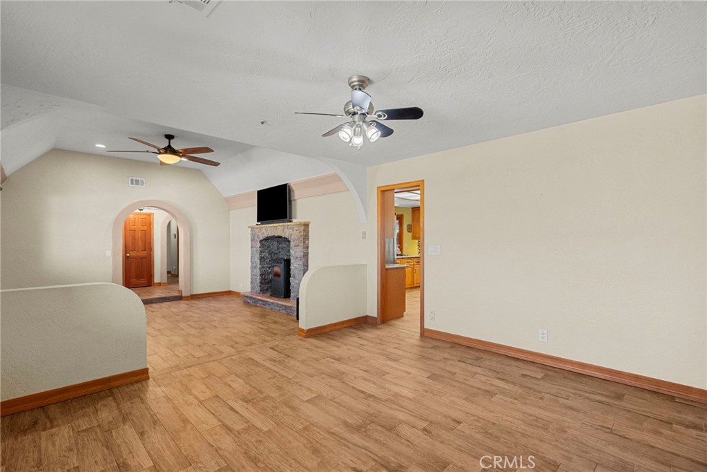 902 Searchlight Ranch Road Acton, CA 93510 - Photo 18 of 52 a view of a livingroom with a fireplace and a chandelier