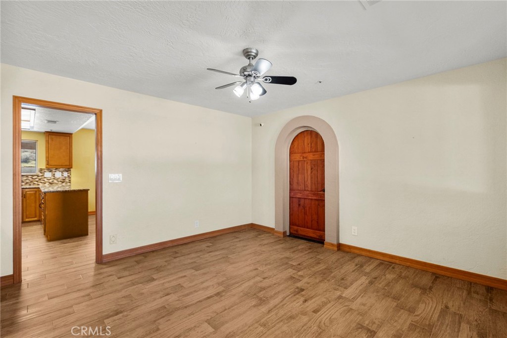 902 Searchlight Ranch Road Acton, CA 93510 - Photo 19 of 52 a view of an empty room with window and wooden floor