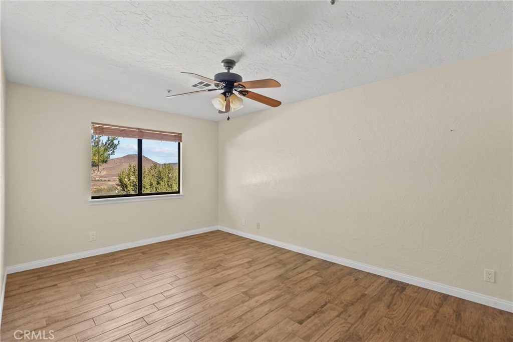902 Searchlight Ranch Road Acton, CA 93510 - Photo 23 of 52 a view of empty room with wooden floor