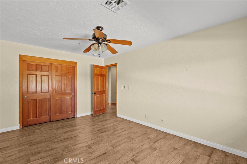 902 Searchlight Ranch Road Acton, CA 93510 - Photo 24 of 52 a view of a livingroom with a chandelier fan and wooden floor