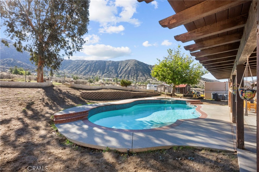 902 Searchlight Ranch Road Acton, CA 93510 - Photo 37 of 52 a view of a swimming pool with a patio