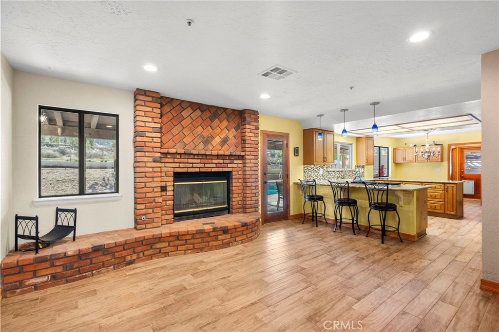 902 Searchlight Ranch Road Acton, CA 93510 - Photo 5 of 52 a living room with chairs flat screen tv and a fireplace
