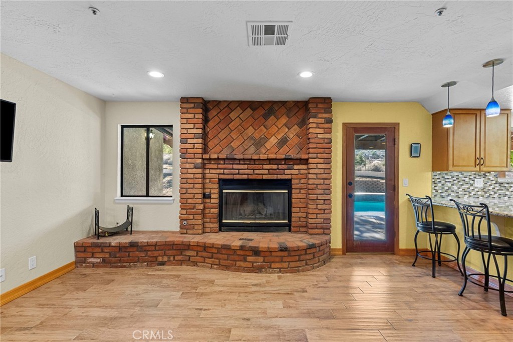 902 Searchlight Ranch Road Acton, CA 93510 - Photo 6 of 52 a living room with furniture and a fireplace
