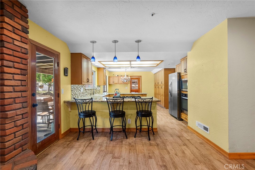 902 Searchlight Ranch Road Acton, CA 93510 - Photo 8 of 52 a dining room with furniture and wooden floor