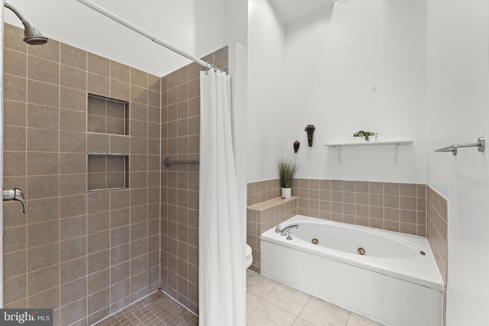 10934 Rocky Mt Way Silver Spring, MD 20902 - Photo 29 of 51 a bathroom with a bathtub and a shower