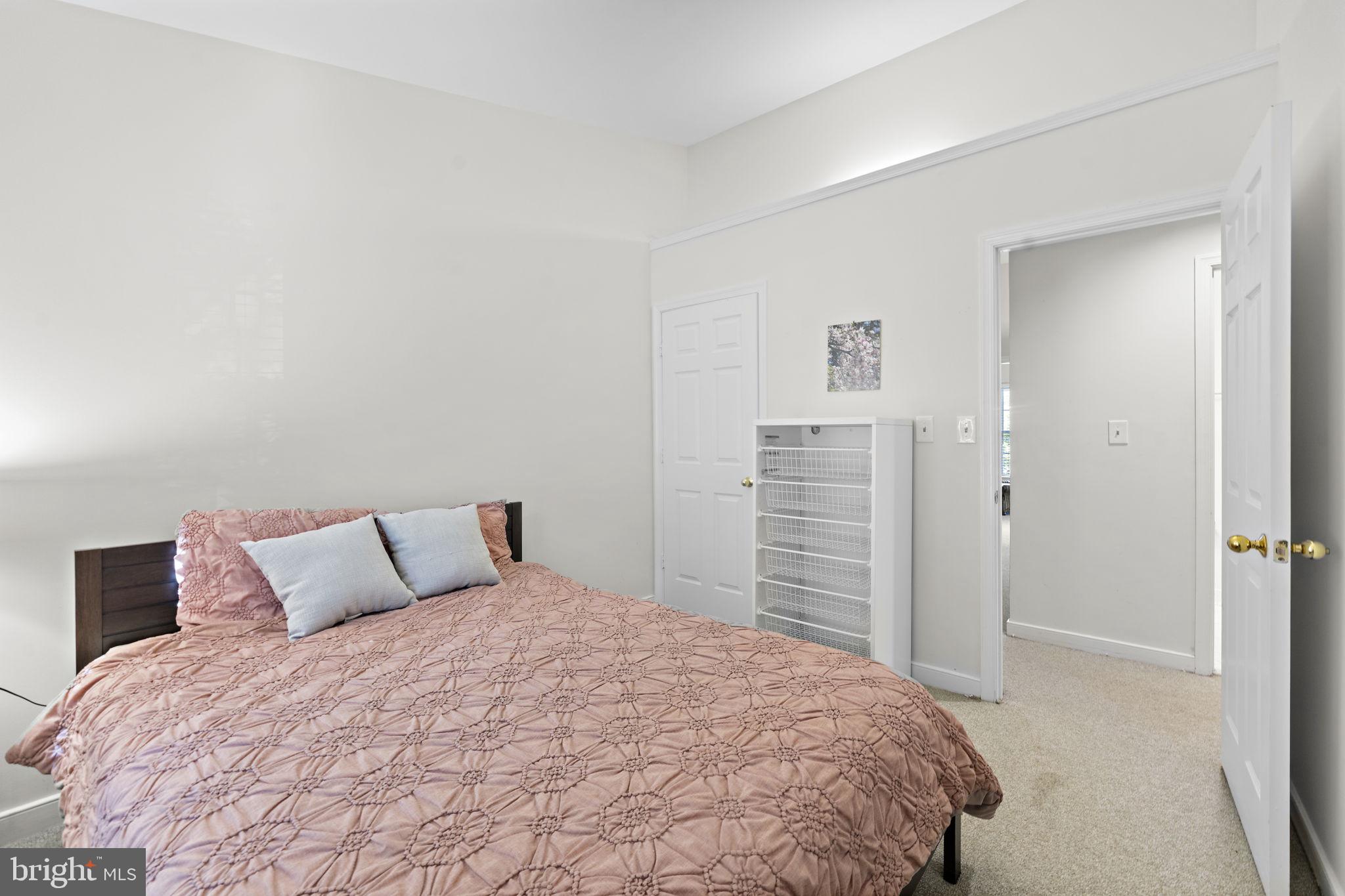 10934 Rocky Mt Way Silver Spring, MD 20902 - Photo 34 of 51 a bedroom with a bed and cabinets