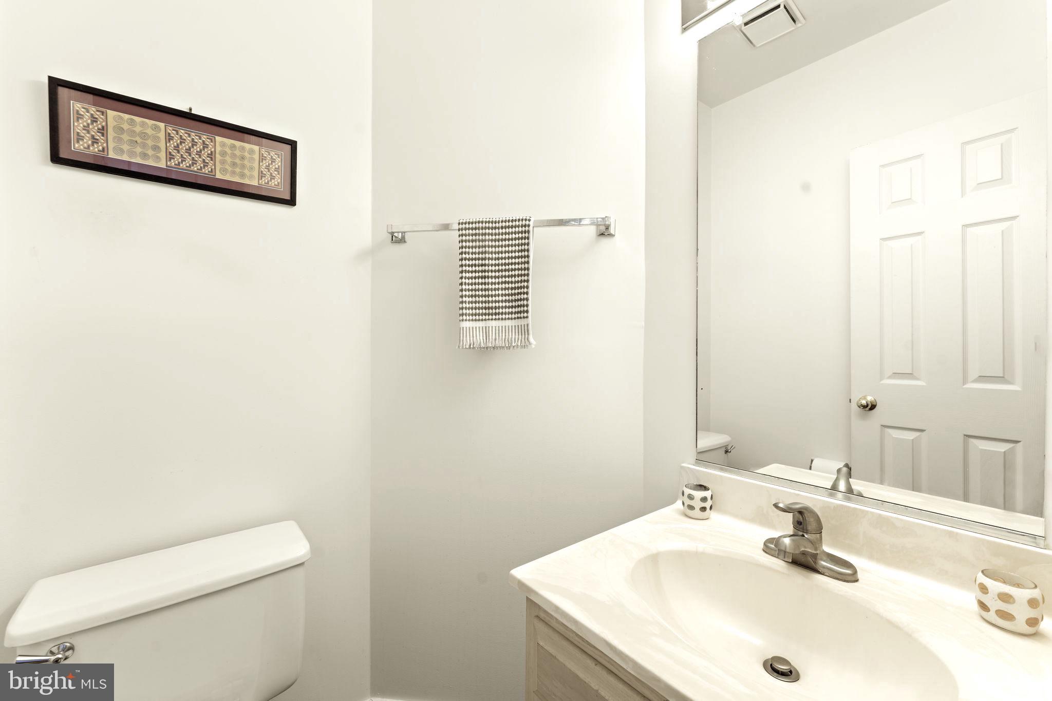 10934 Rocky Mt Way Silver Spring, MD 20902 - Photo 37 of 51 a bathroom with a sink a toilet and mirror