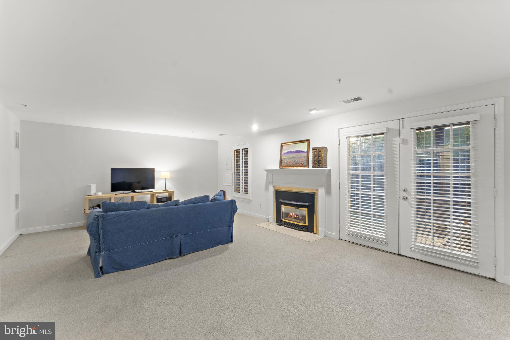 10934 Rocky Mt Way Silver Spring, MD 20902 - Photo 39 of 51 a living room with furniture and a flat screen tv