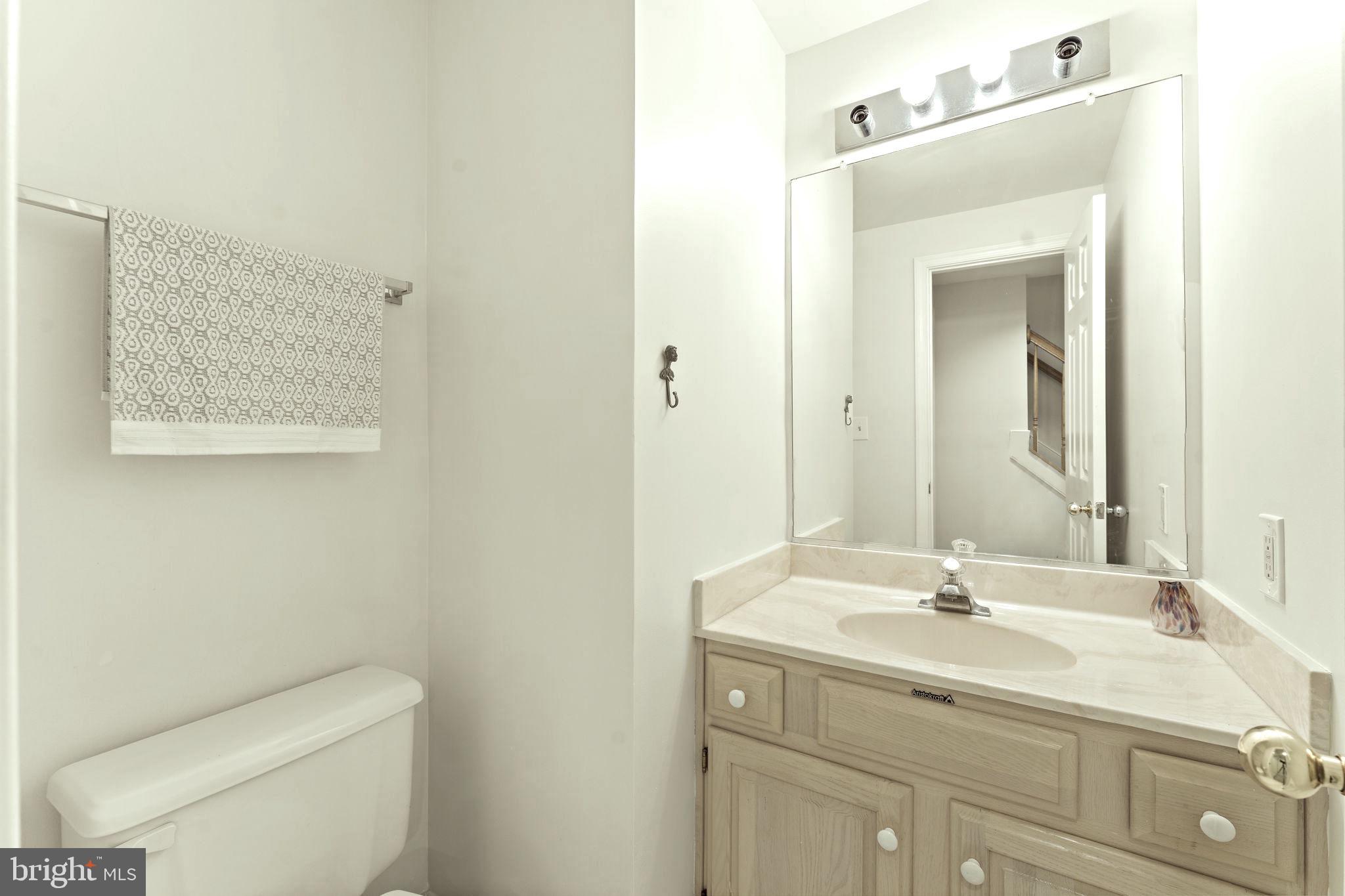 10934 Rocky Mt Way Silver Spring, MD 20902 - Photo 43 of 51 a bathroom with a toilet sink and mirror