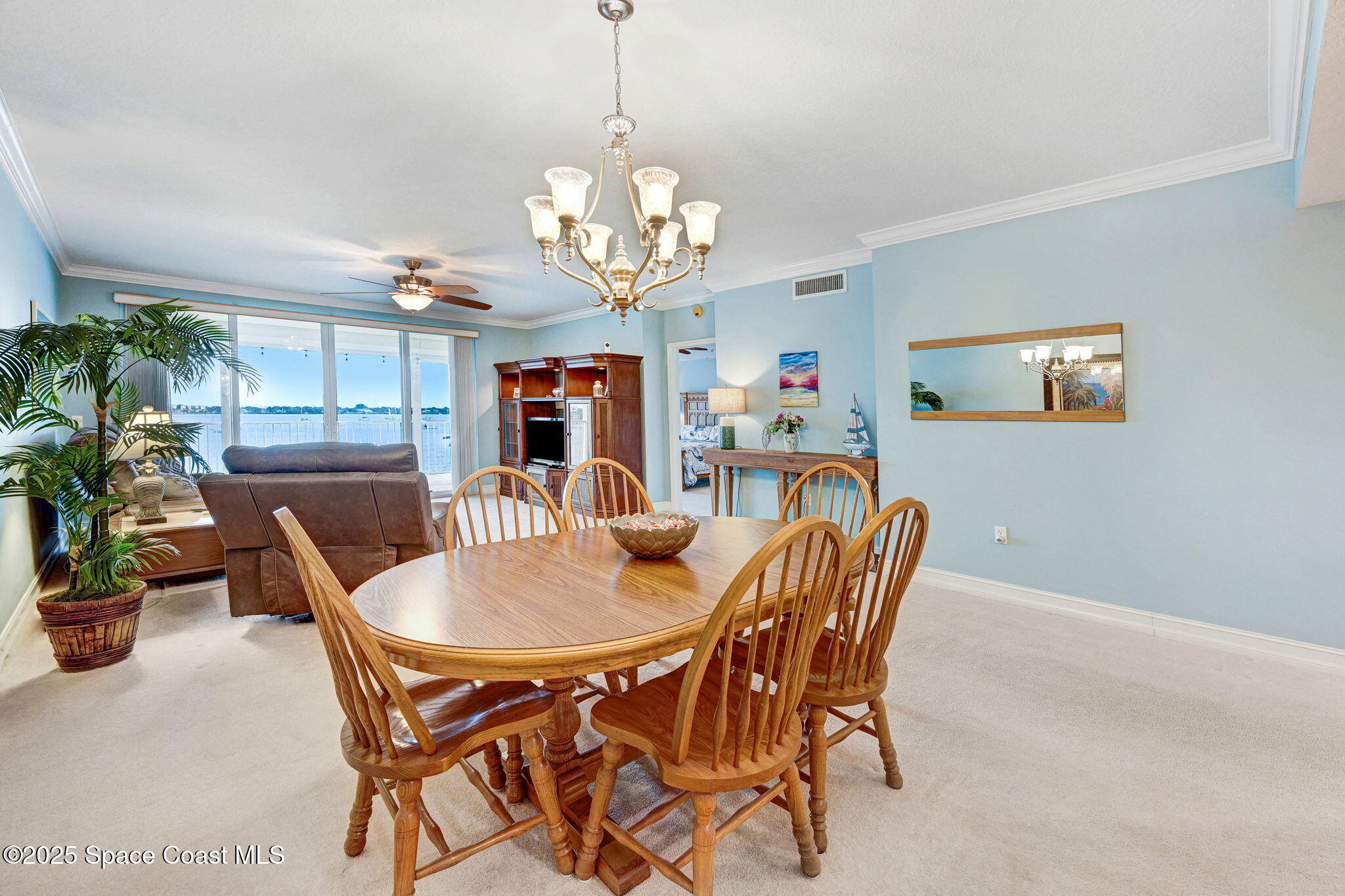 500 Sail Lane, Unit 203 Merritt Island, FL 32953 - Photo 14 of 52 a dining room with furniture a chandelier and window