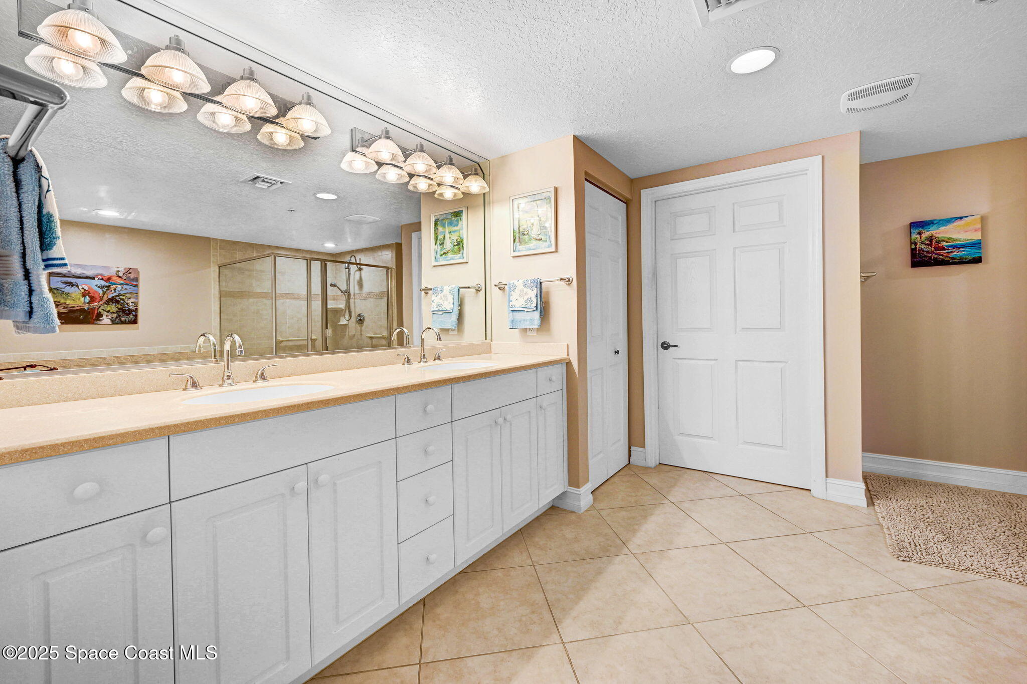 500 Sail Lane, Unit 203 Merritt Island, FL 32953 - Photo 20 of 52 a spacious bathroom with a double vanity sink mirror and chandelier