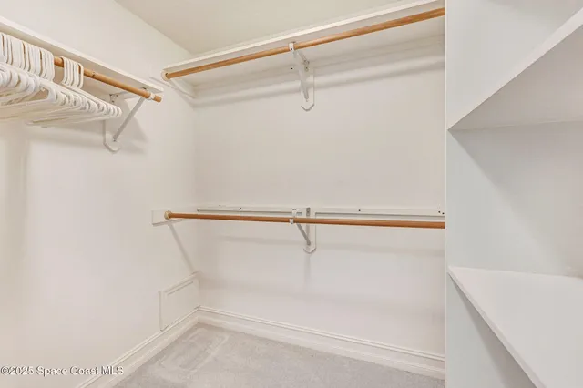 a bedroom with a bed a lamp and a large window