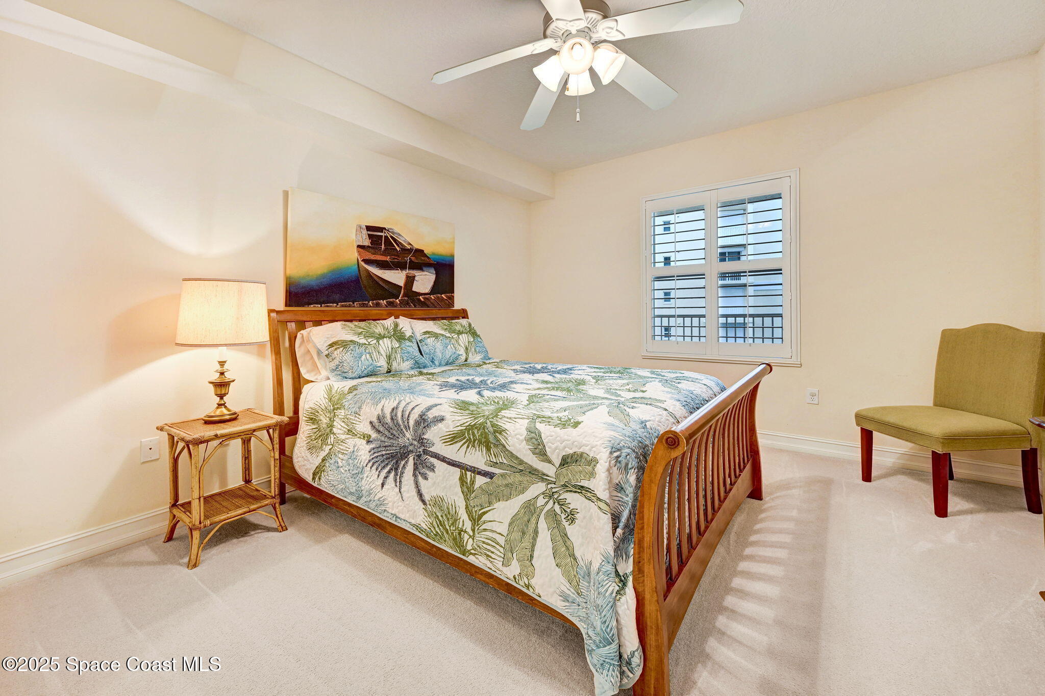 500 Sail Lane, Unit 203 Merritt Island, FL 32953 - Photo 23 of 52 a bedroom with a bed and a chandelier