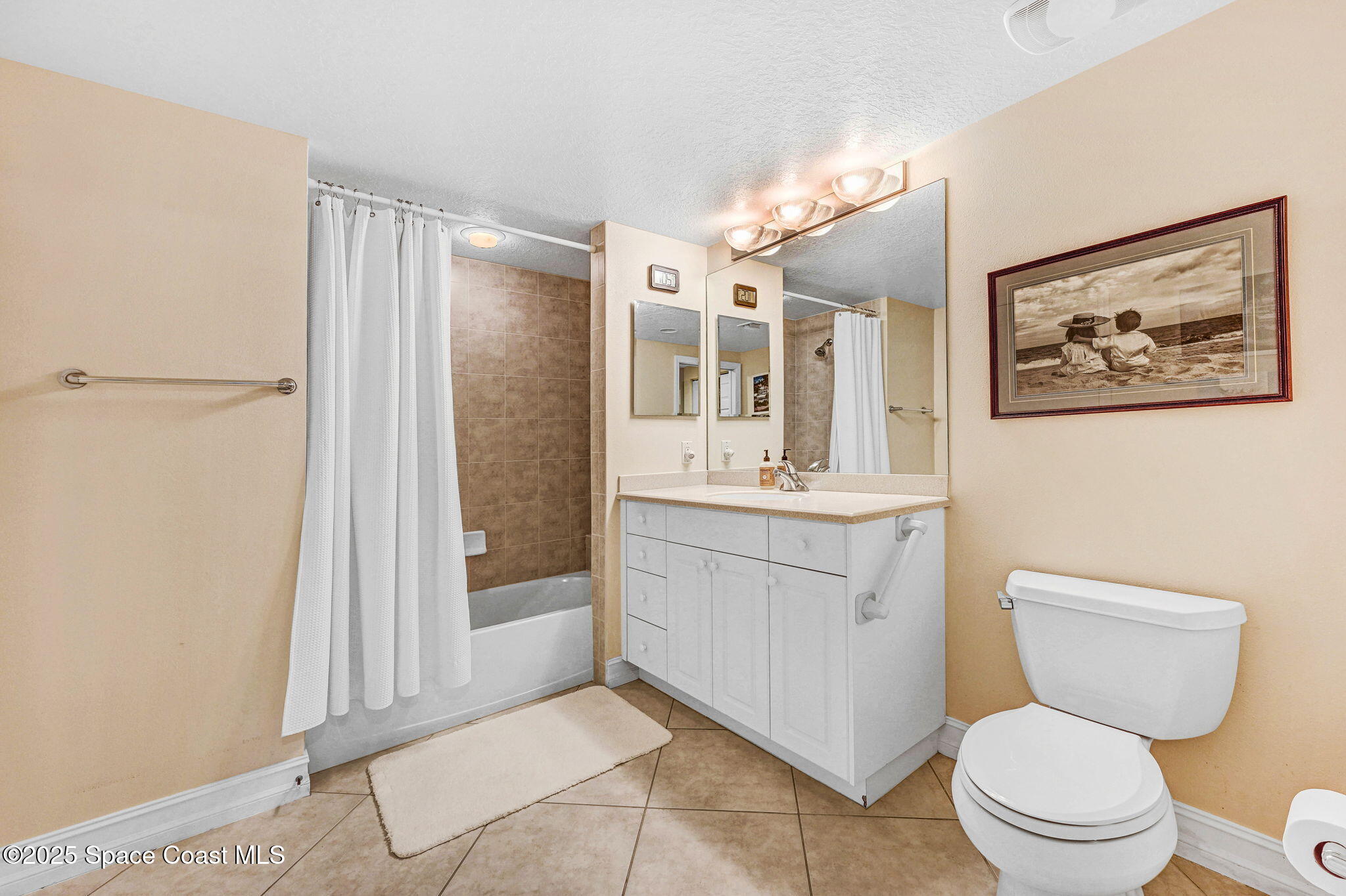 500 Sail Lane, Unit 203 Merritt Island, FL 32953 - Photo 25 of 52 a bathroom with a toilet a sink tub and mirror