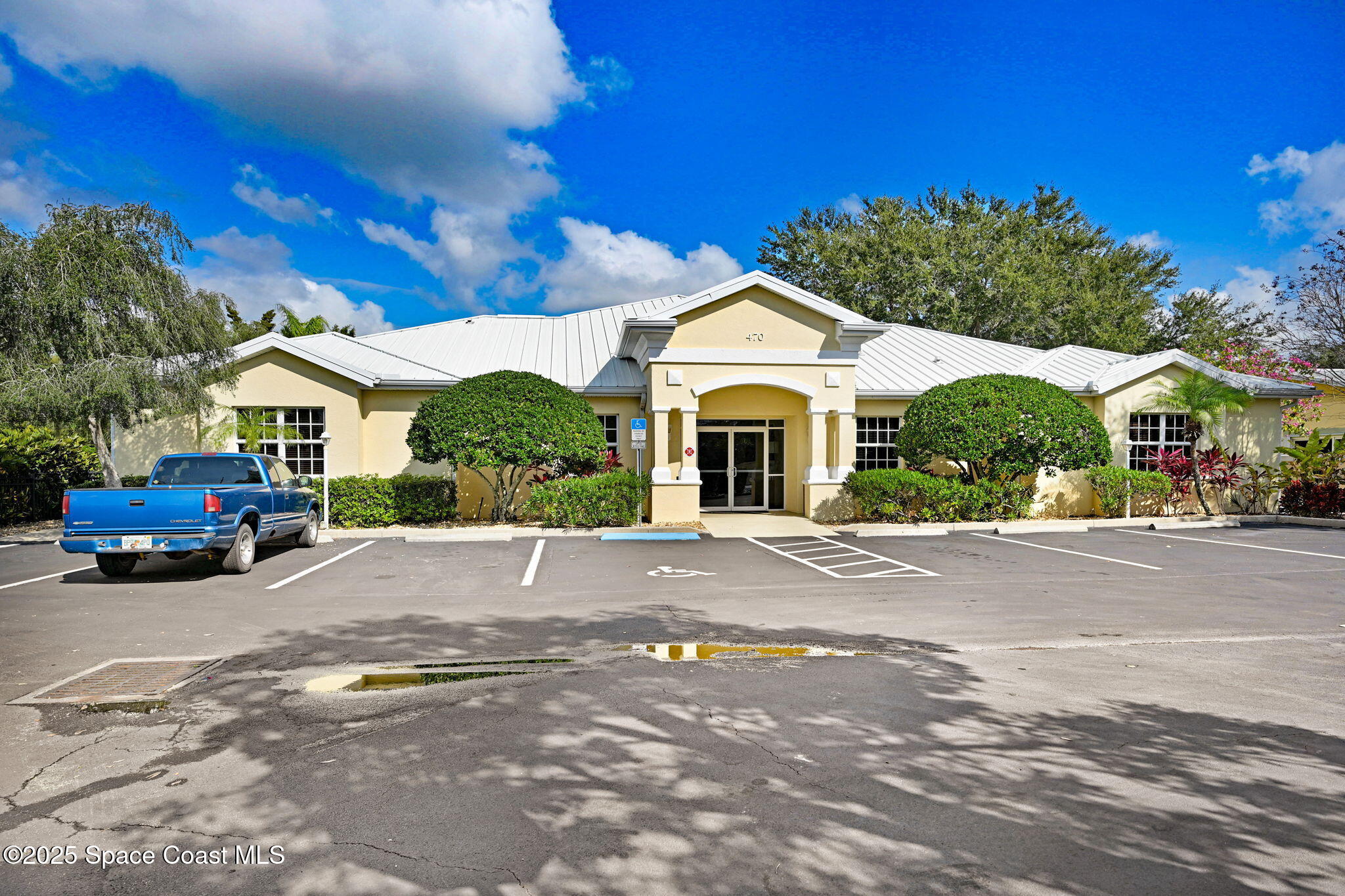 500 Sail Lane, Unit 203 Merritt Island, FL 32953 - Photo 33 of 52 a building with trees in front of it