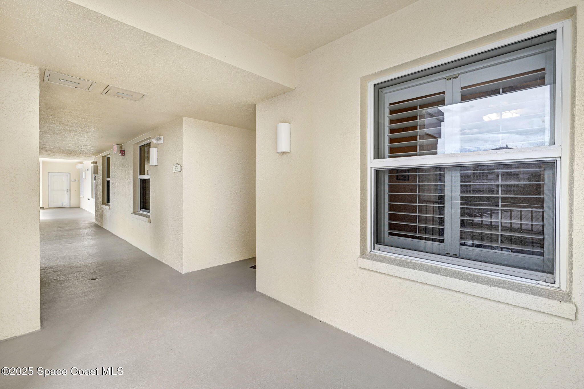 500 Sail Lane, Unit 203 Merritt Island, FL 32953 - Photo 7 of 52 a view of an empty room with a window