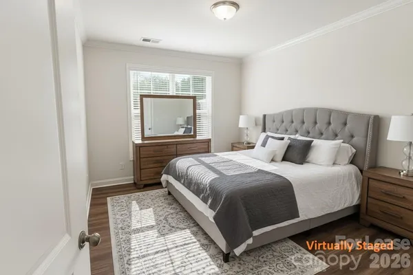 a large bed sitting in a bedroom next to a window