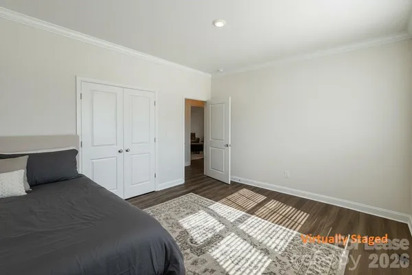 a bedroom with a bed and a night stand