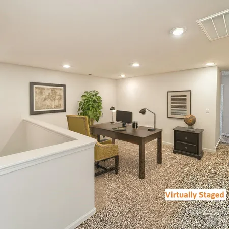 a living room with furniture a flat screen tv and a table