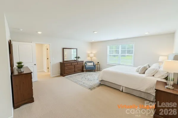 a spacious bedroom with a bed and a couch