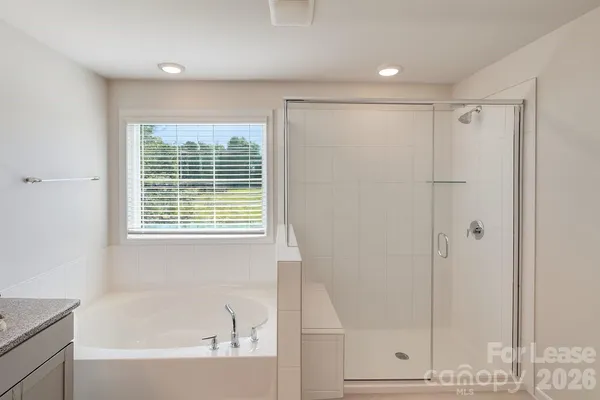 a bathroom with a bathtub and a shower