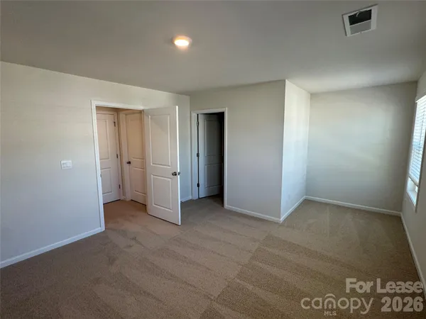 an empty room with closet area