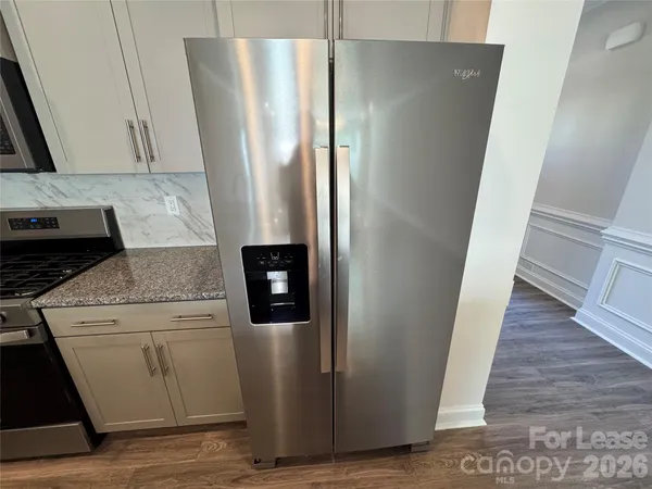 a close view of a refrigerator in kitchen and a stove