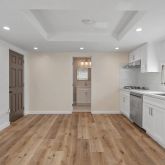 a kitchen with kitchen island a sink cabinets stainless steel appliances and a window