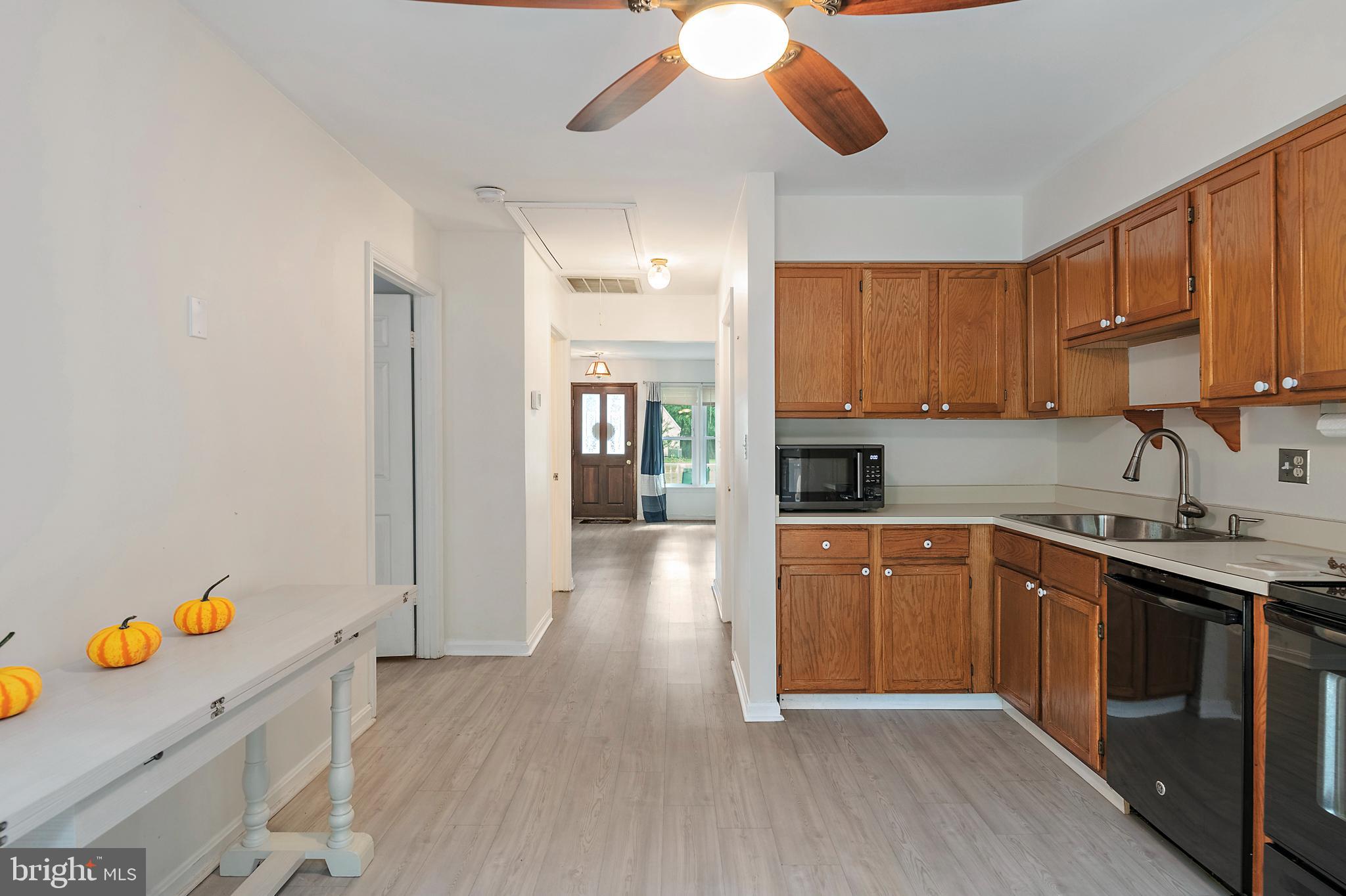 932 Riversedge Circle Annapolis, MD 21401 - Photo 14 of 42 a kitchen with stainless steel appliances granite countertop a refrigerator a sink dishwasher and white cabinets with wooden floor