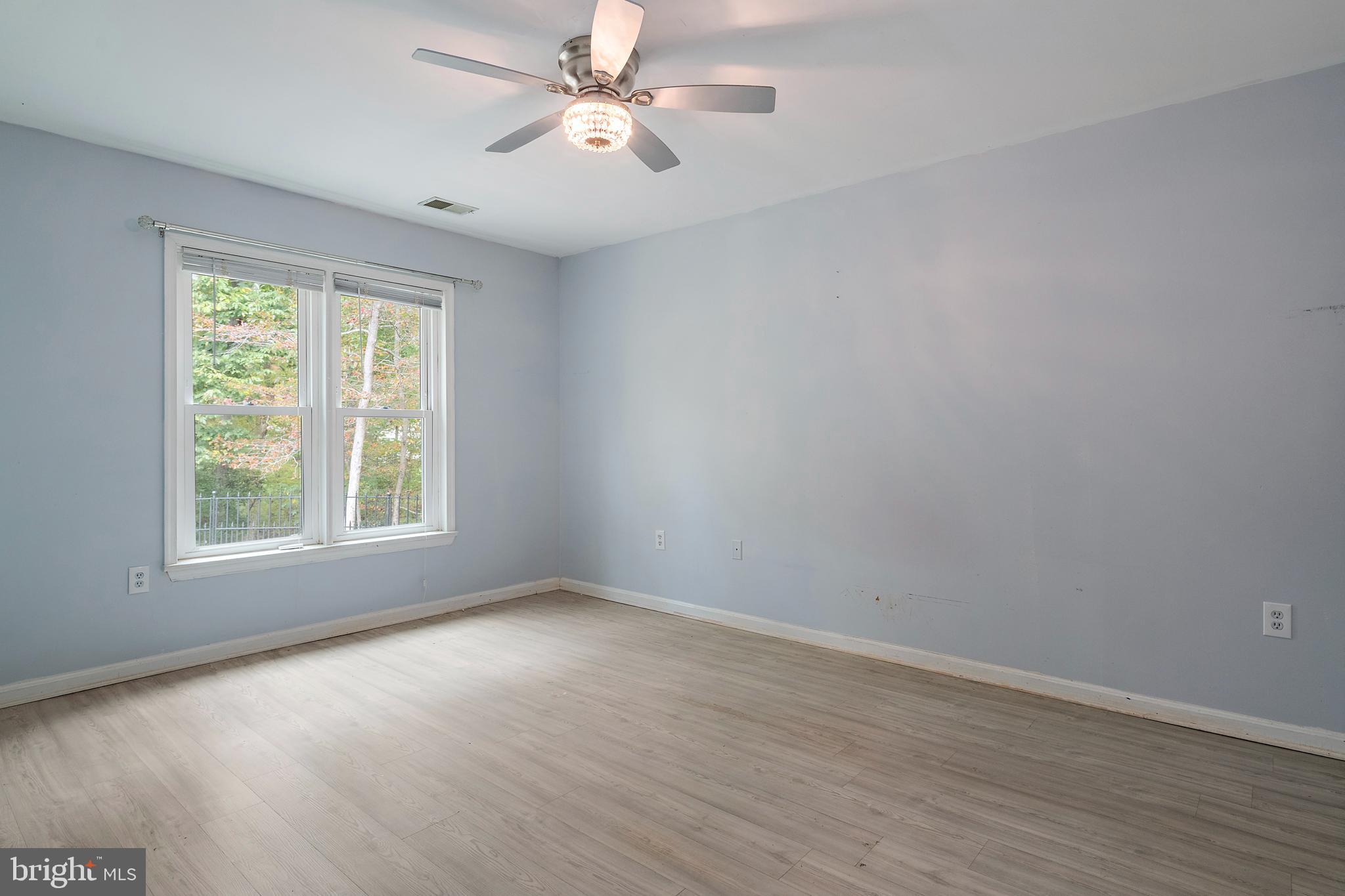 932 Riversedge Circle Annapolis, MD 21401 - Photo 20 of 42 a view of empty room with wooden floor and fan