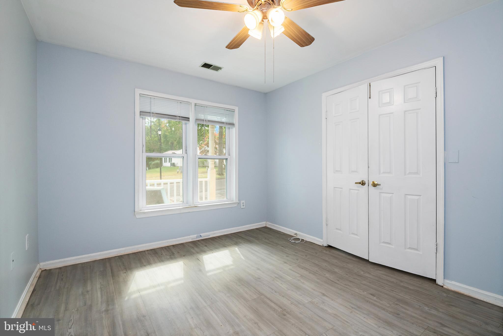 932 Riversedge Circle Annapolis, MD 21401 - Photo 20 of 42 a view of an empty room with wooden floor and a window
