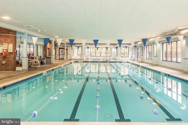 a large white building with swimming pool in front of it