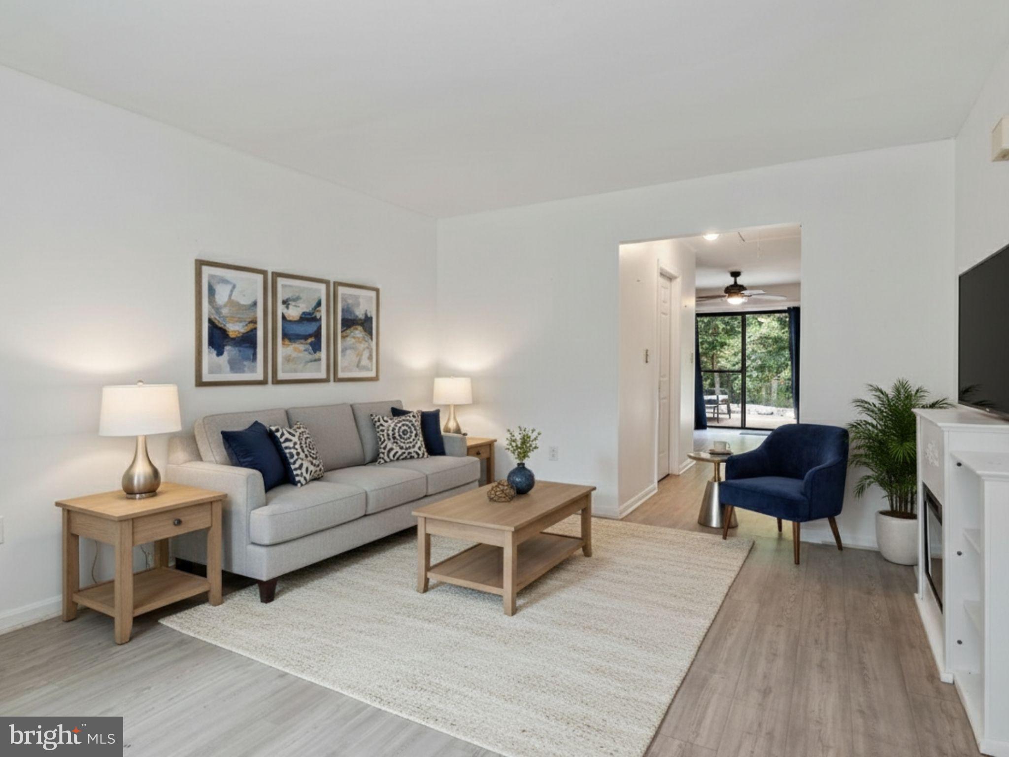 932 Riversedge Circle Annapolis, MD 21401 - Photo 6 of 42 a living room with furniture and a painting on the wall