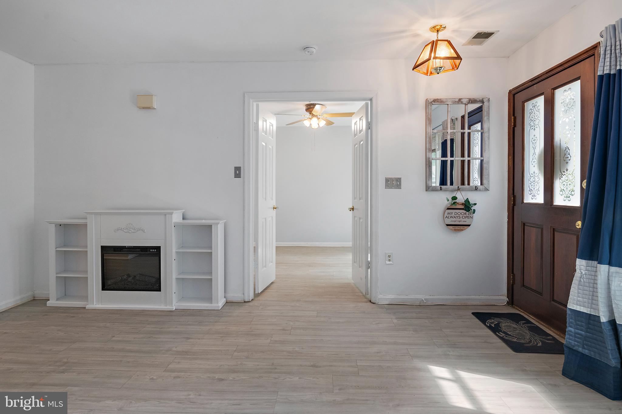 932 Riversedge Circle Annapolis, MD 21401 - Photo 7 of 42 a view of a hallway with wooden floor and a fireplace