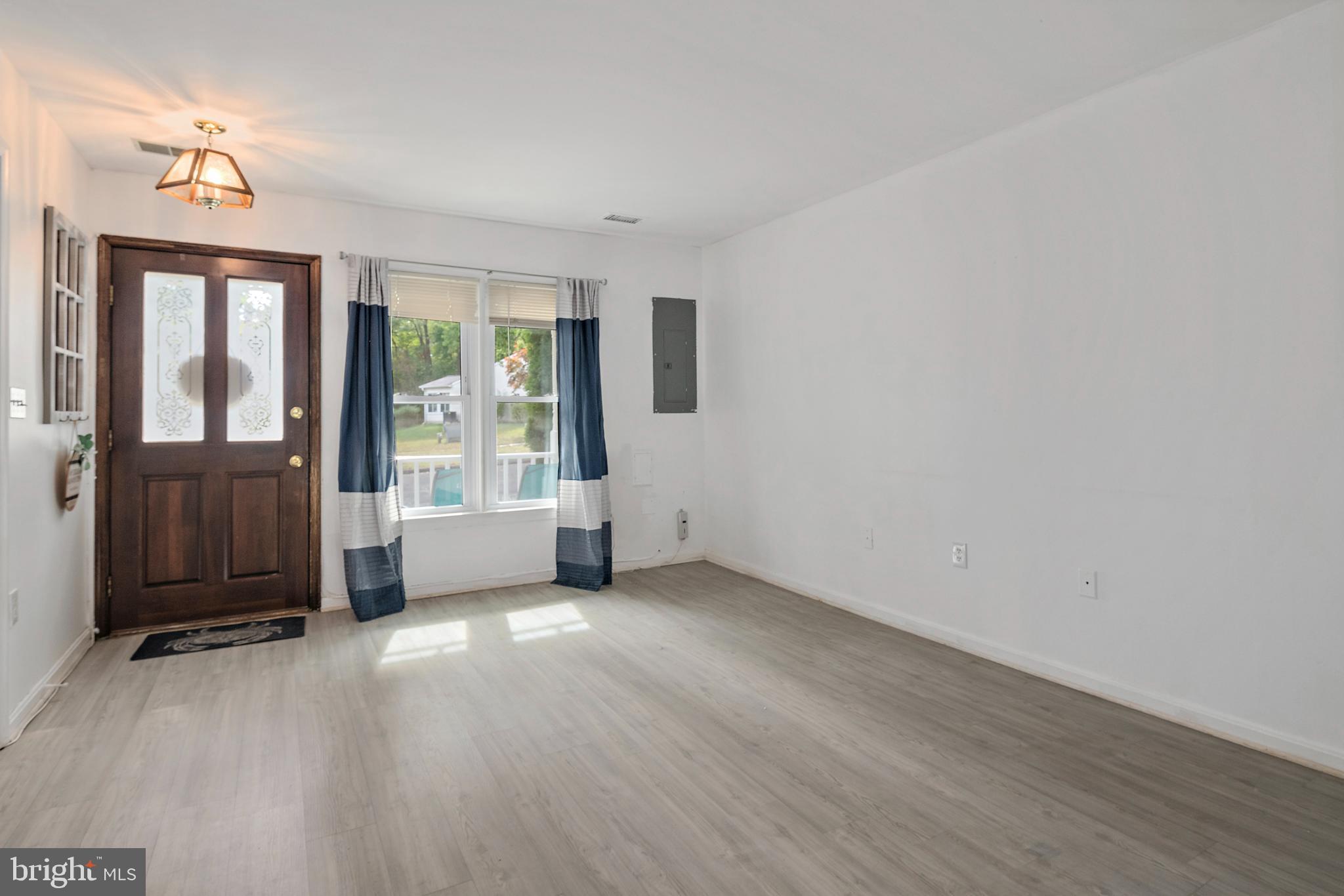 932 Riversedge Circle Annapolis, MD 21401 - Photo 8 of 42 an empty room with wooden floor and windows