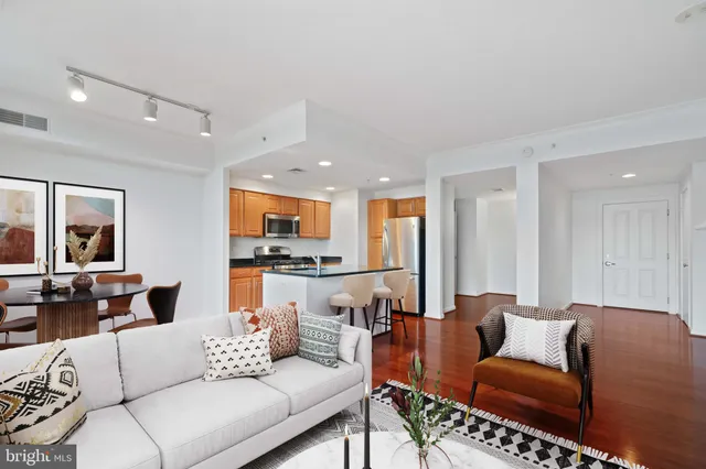 a living room with furniture kitchen view and a table